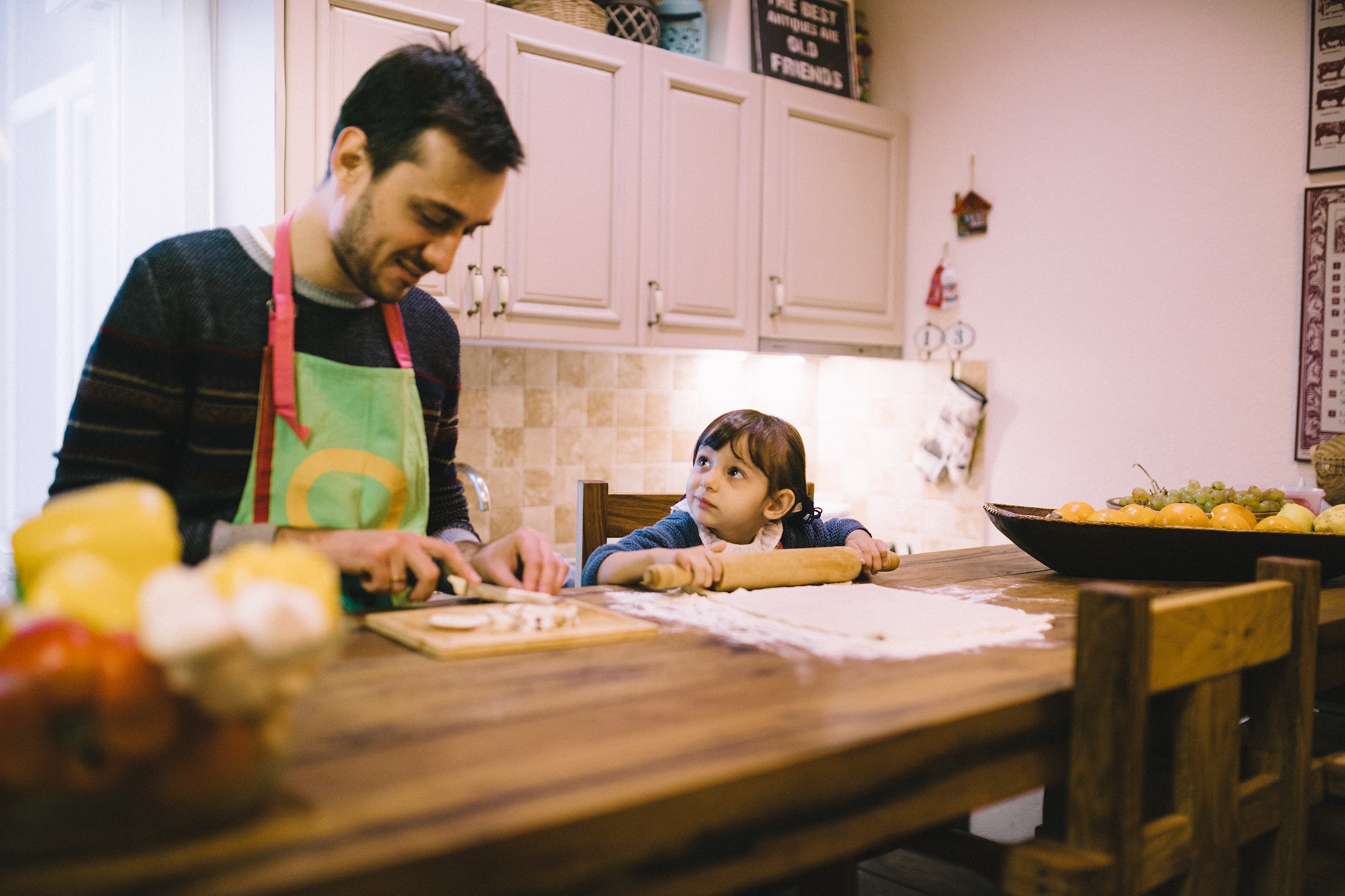 Father and toddler cooking